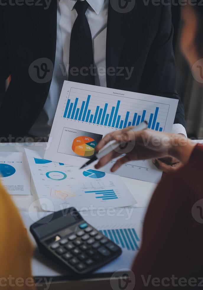 Financial analysts analyze business financial reports on a digital tablet planning investment project during a discussion at a meeting of corporate showing the results of their successful teamwork. photo