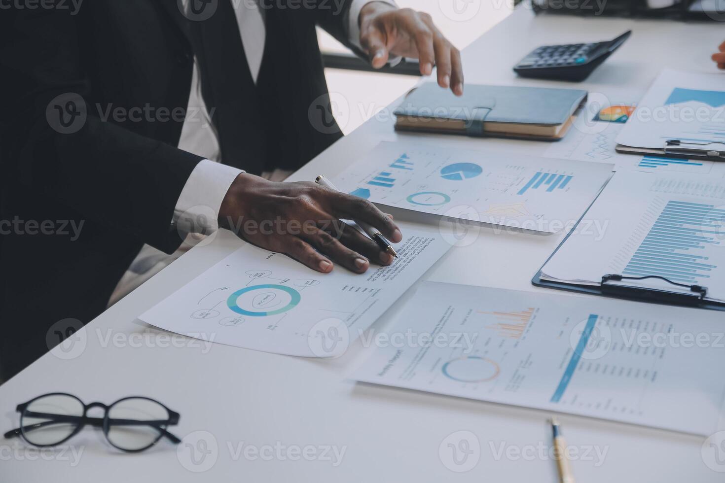 Financial analysts analyze business financial reports on a digital tablet planning investment project during a discussion at a meeting of corporate showing the results of their successful teamwork. photo