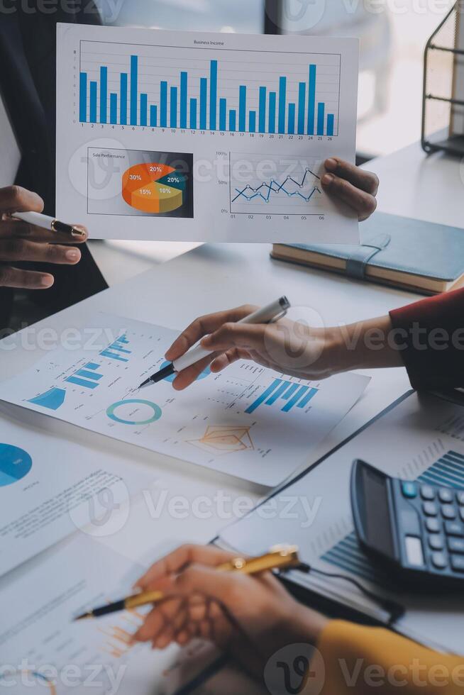 Financial analysts analyze business financial reports on a digital tablet planning investment project during a discussion at a meeting of corporate showing the results of their successful teamwork. photo
