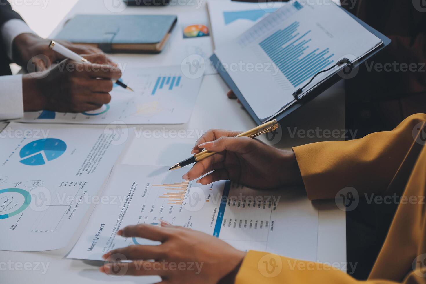 Financial analysts analyze business financial reports on a digital tablet planning investment project during a discussion at a meeting of corporate showing the results of their successful teamwork. photo
