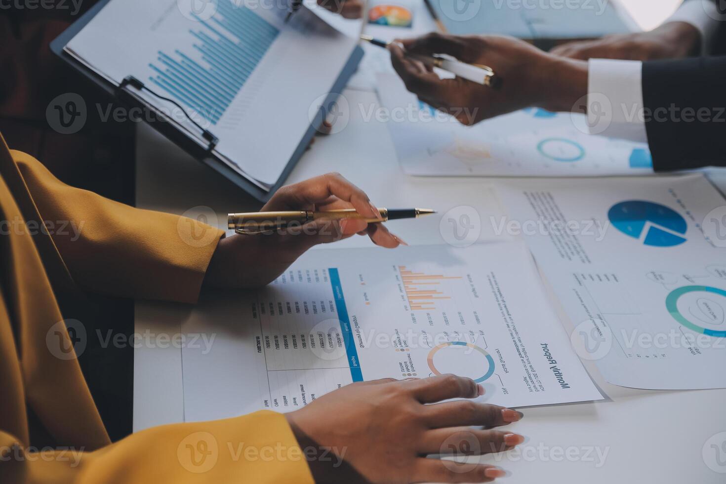 Financial analysts analyze business financial reports on a digital tablet planning investment project during a discussion at a meeting of corporate showing the results of their successful teamwork. photo