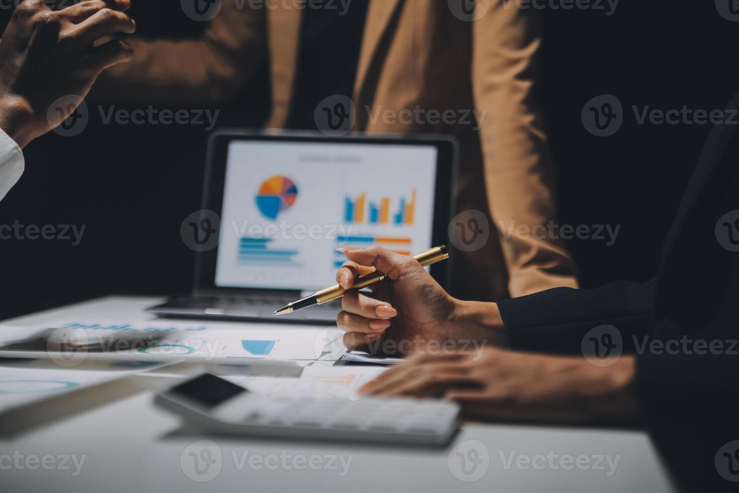 Financial analysts analyze business financial reports on a digital tablet planning investment project during a discussion at a meeting of corporate showing the results of their successful teamwork. photo
