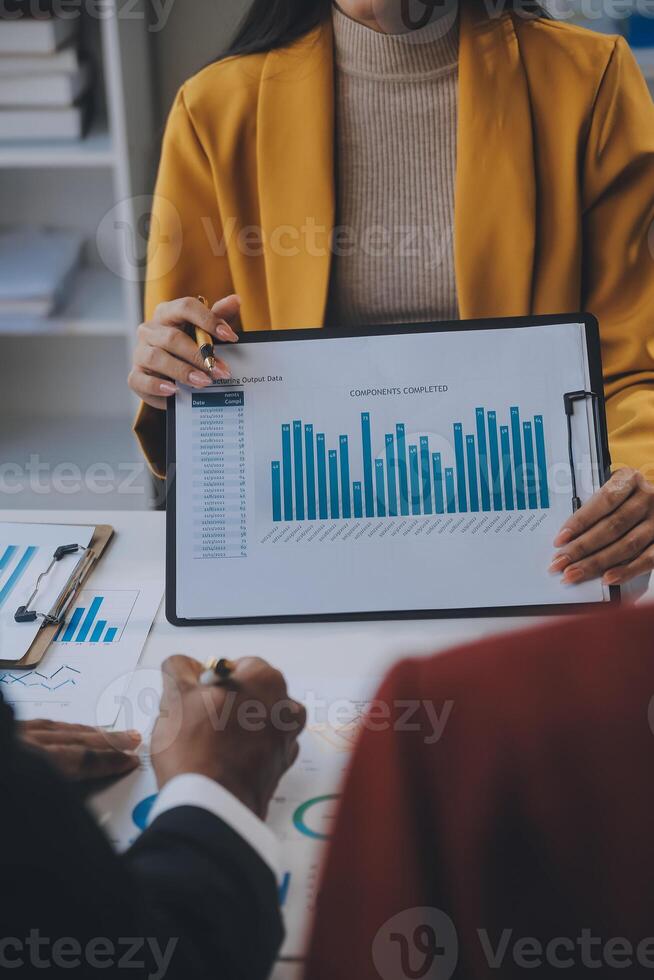 Financial analysts analyze business financial reports on a digital tablet planning investment project during a discussion at a meeting of corporate showing the results of their successful teamwork. photo