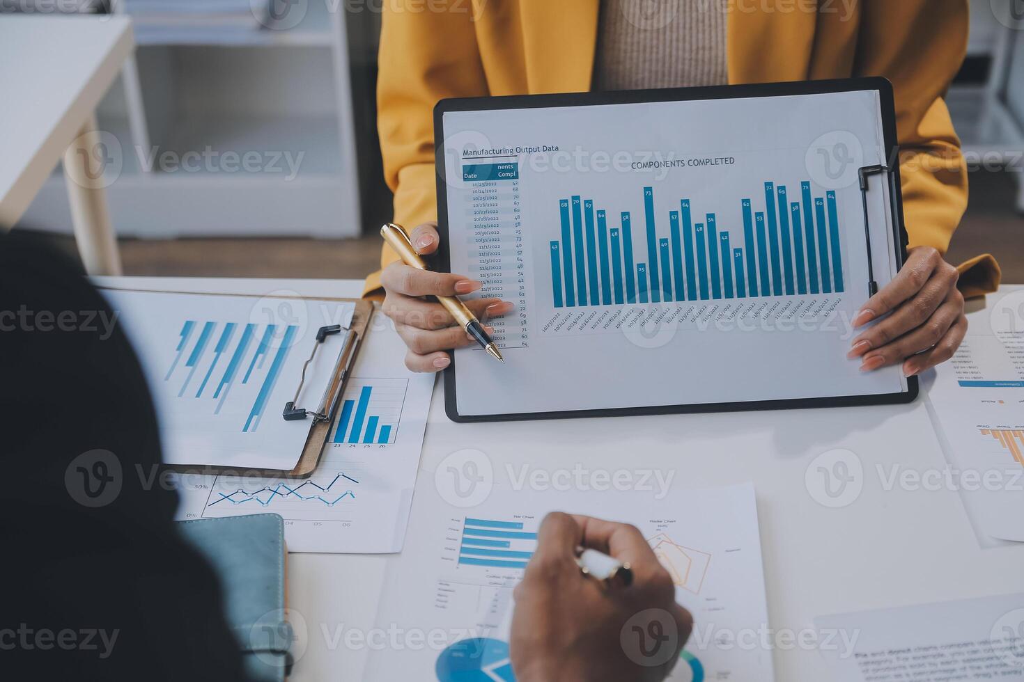 Financial analysts analyze business financial reports on a digital tablet planning investment project during a discussion at a meeting of corporate showing the results of their successful teamwork. photo