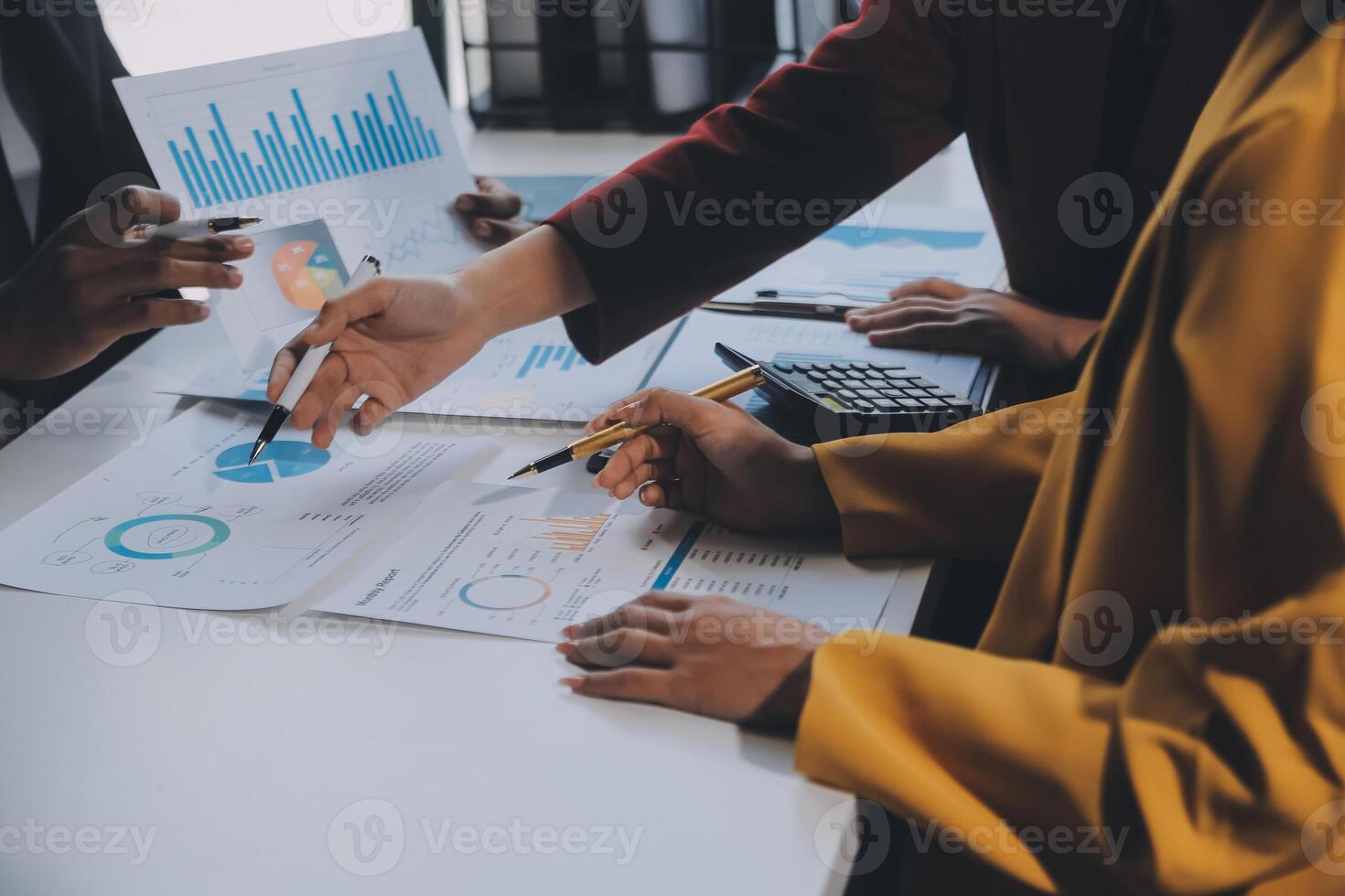Financial analysts analyze business financial reports on a digital tablet planning investment project during a discussion at a meeting of corporate showing the results of their successful teamwork. photo