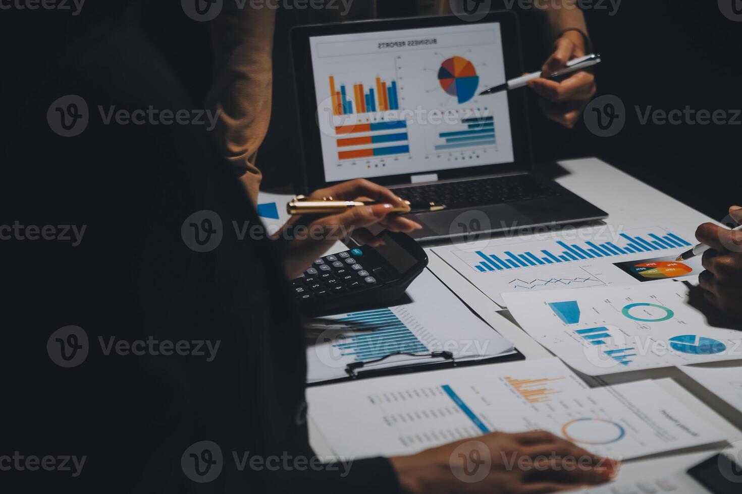 Financial analysts analyze business financial reports on a digital tablet planning investment project during a discussion at a meeting of corporate showing the results of their successful teamwork. photo