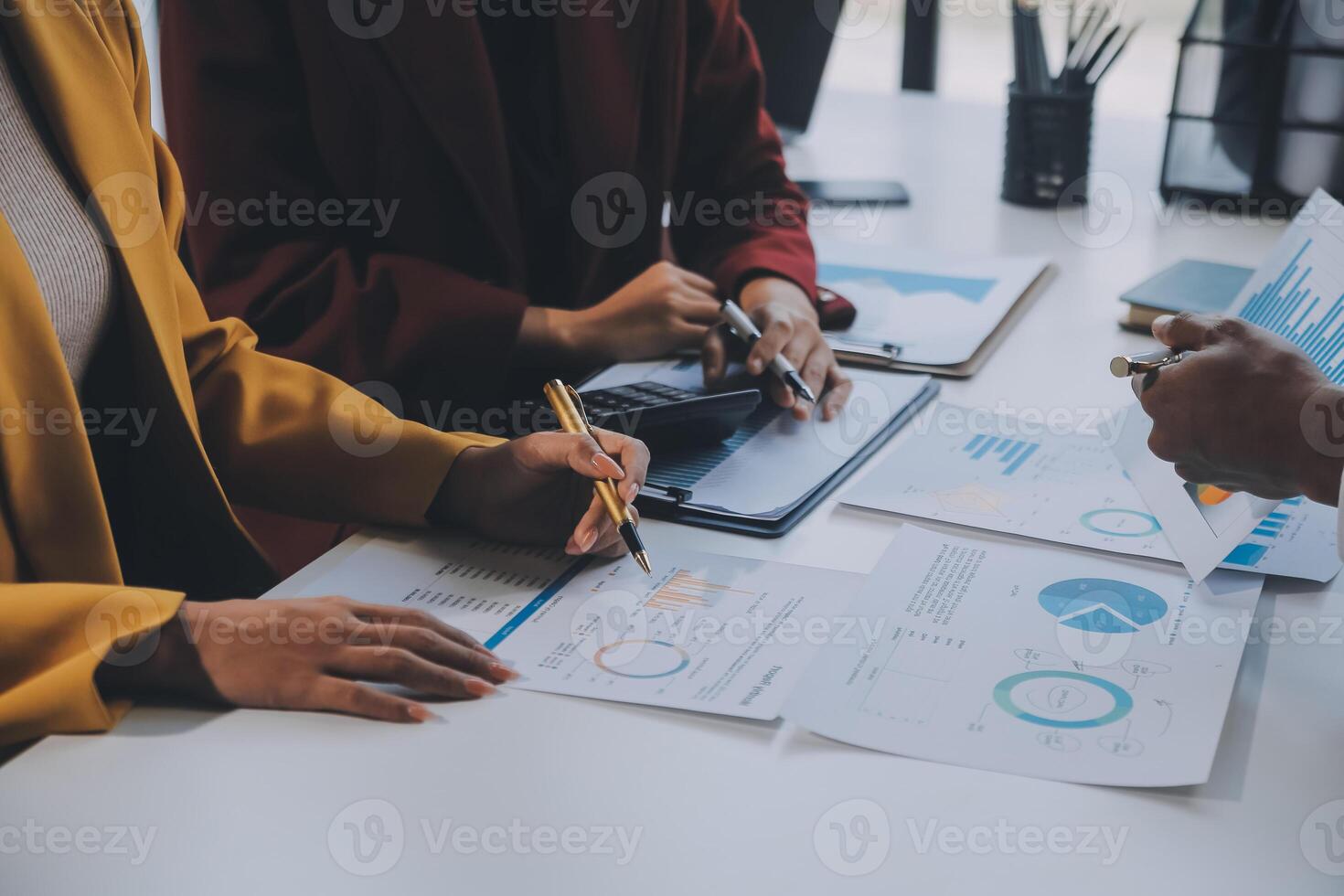 Financial analysts analyze business financial reports on a digital tablet planning investment project during a discussion at a meeting of corporate showing the results of their successful teamwork. photo