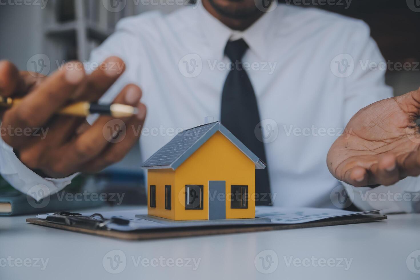 Real estate agent and customer signing contract to buy house, insurance or loan real estate.rent a house,get insurance or loan real estate or property. photo