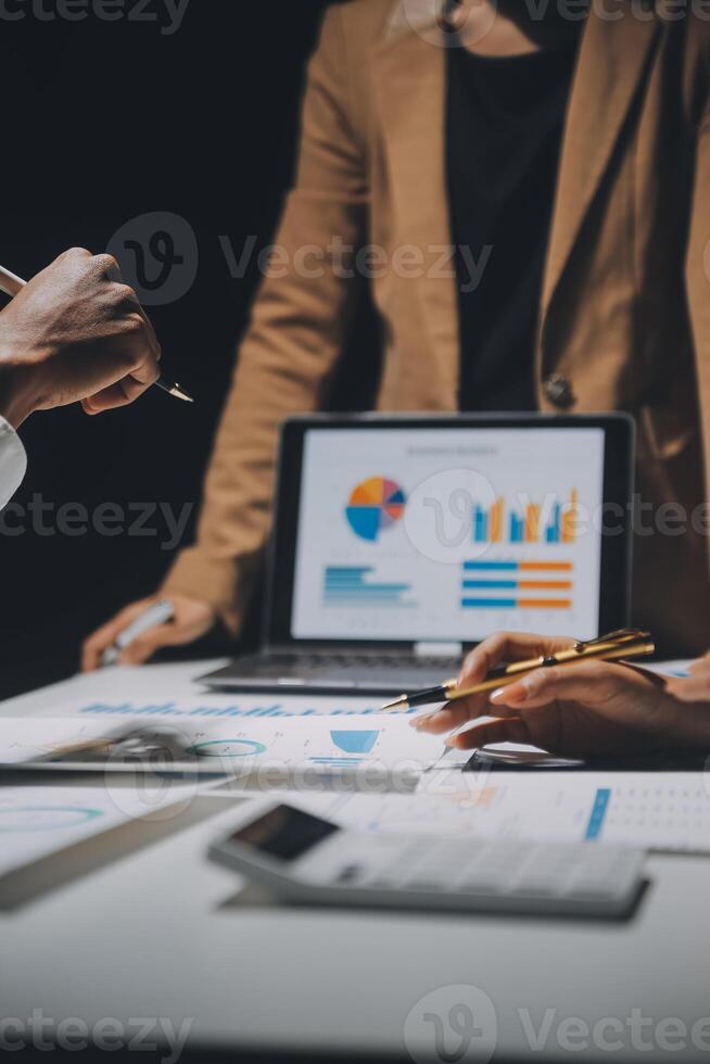 Financial analysts analyze business financial reports on a digital tablet planning investment project during a discussion at a meeting of corporate showing the results of their successful teamwork. photo