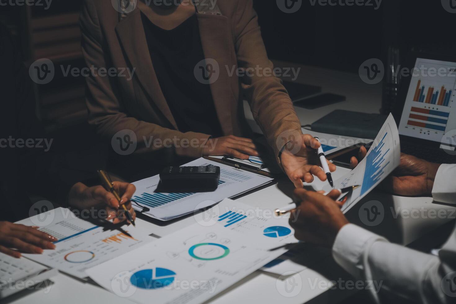 Financial analysts analyze business financial reports on a digital tablet planning investment project during a discussion at a meeting of corporate showing the results of their successful teamwork. photo