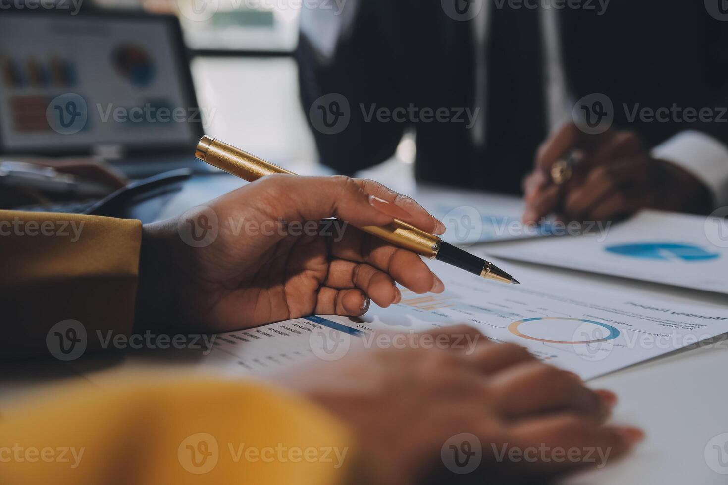 Financial analysts analyze business financial reports on a digital tablet planning investment project during a discussion at a meeting of corporate showing the results of their successful teamwork. photo