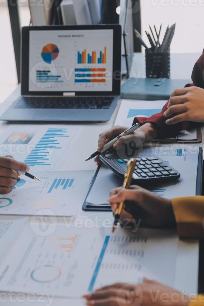 Financial analysts analyze business financial reports on a digital tablet planning investment project during a discussion at a meeting of corporate showing the results of their successful teamwork. photo