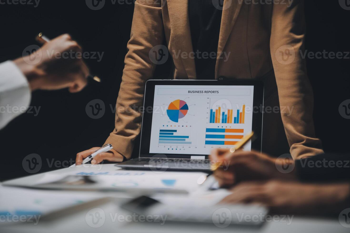 Financial analysts analyze business financial reports on a digital tablet planning investment project during a discussion at a meeting of corporate showing the results of their successful teamwork. photo