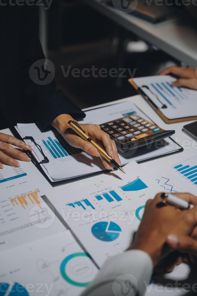 Financial analysts analyze business financial reports on a digital tablet planning investment project during a discussion at a meeting of corporate showing the results of their successful teamwork. photo