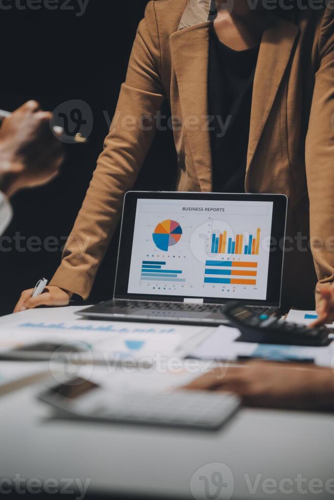 Financial analysts analyze business financial reports on a digital tablet planning investment project during a discussion at a meeting of corporate showing the results of their successful teamwork. photo