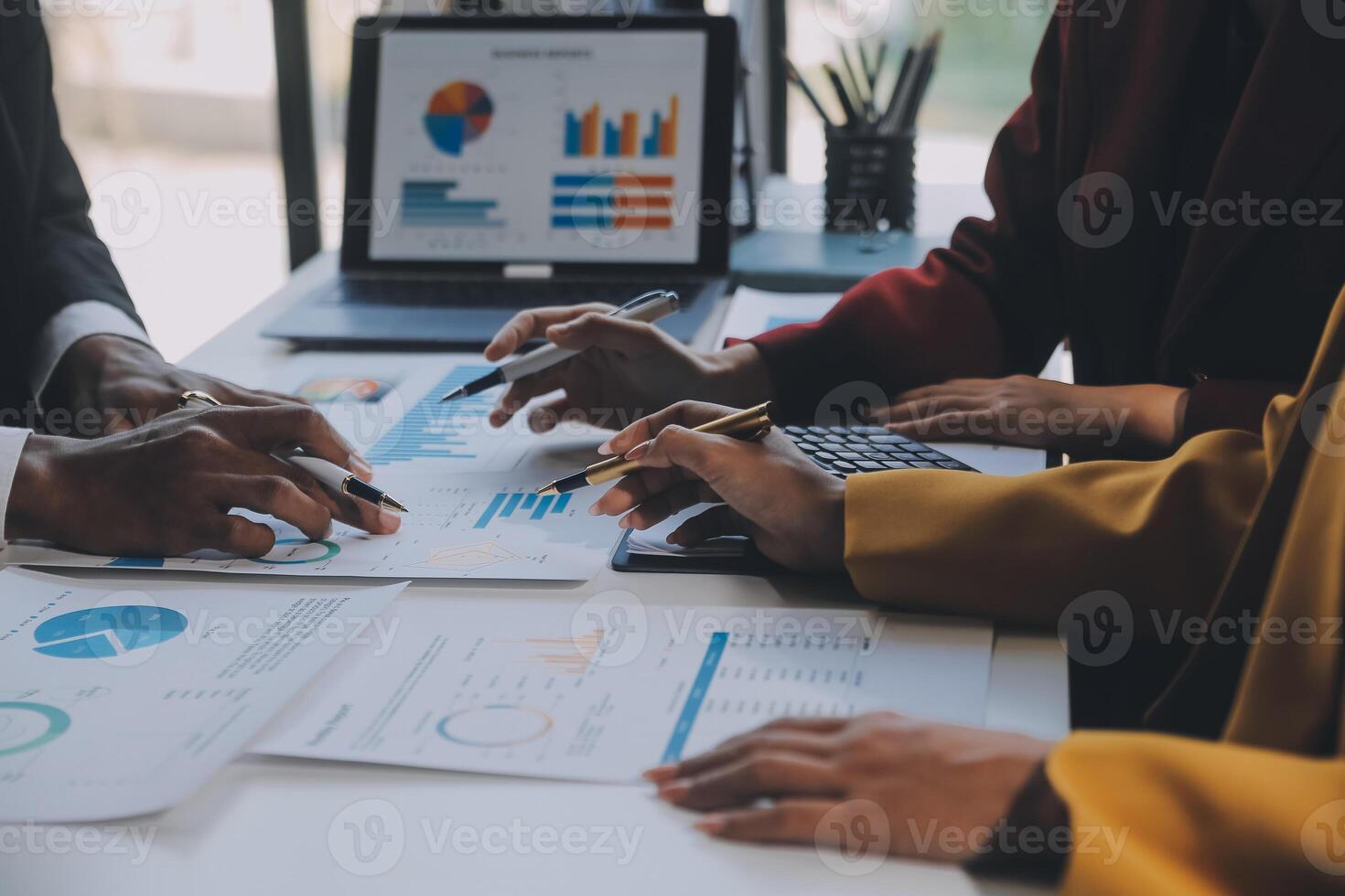 Financial analysts analyze business financial reports on a digital tablet planning investment project during a discussion at a meeting of corporate showing the results of their successful teamwork. photo