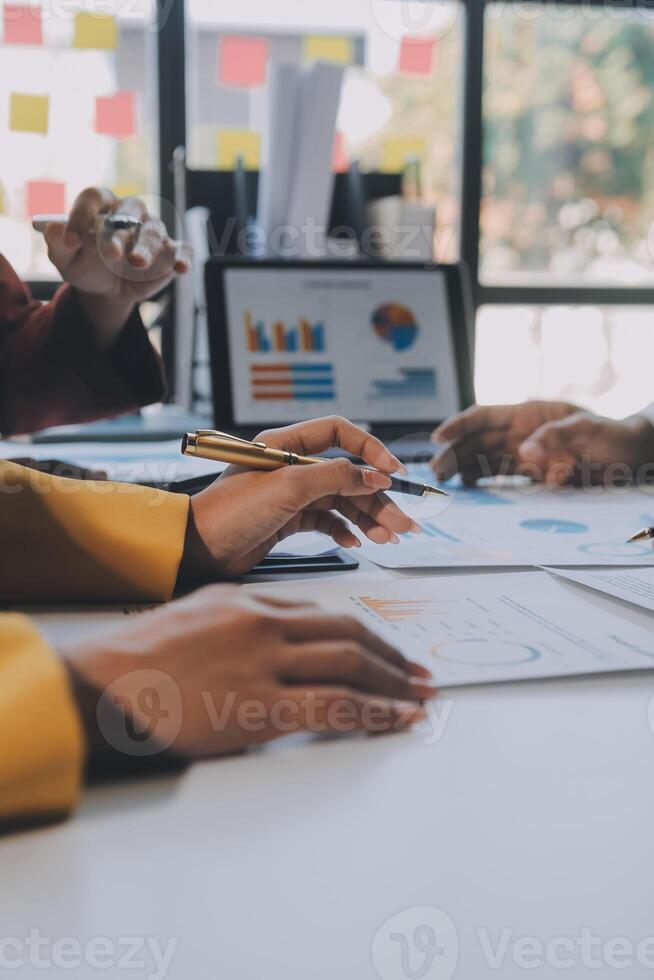 Financial analysts analyze business financial reports on a digital tablet planning investment project during a discussion at a meeting of corporate showing the results of their successful teamwork. photo