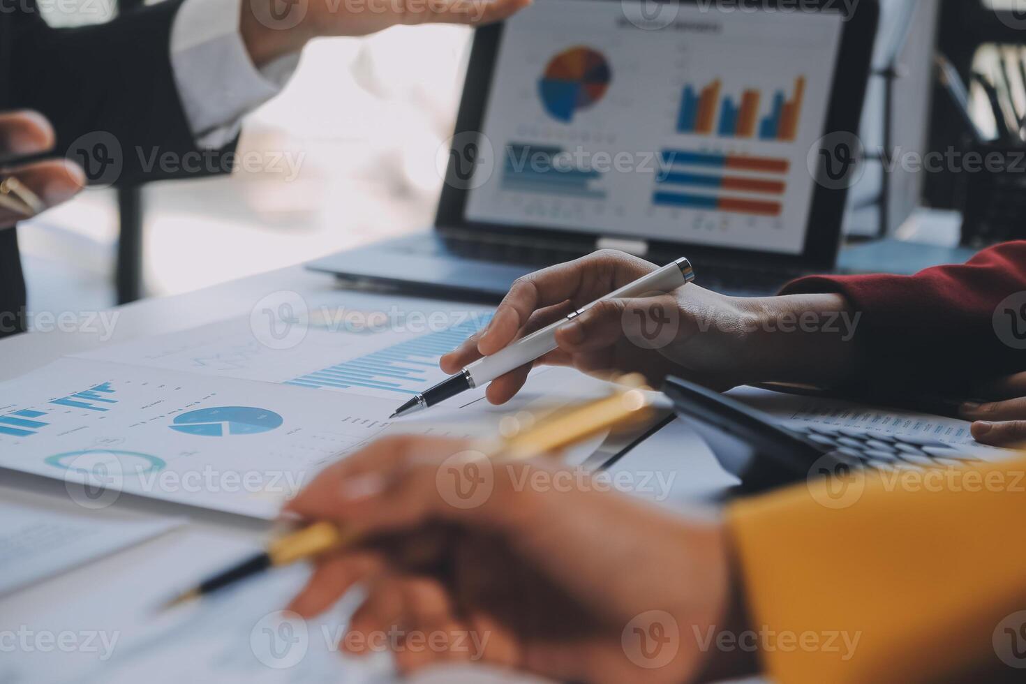 Financial analysts analyze business financial reports on a digital tablet planning investment project during a discussion at a meeting of corporate showing the results of their successful teamwork. photo