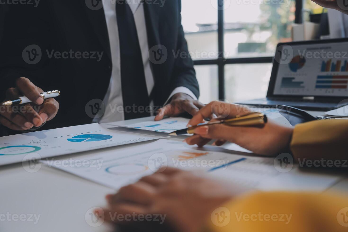 Financial analysts analyze business financial reports on a digital tablet planning investment project during a discussion at a meeting of corporate showing the results of their successful teamwork. photo