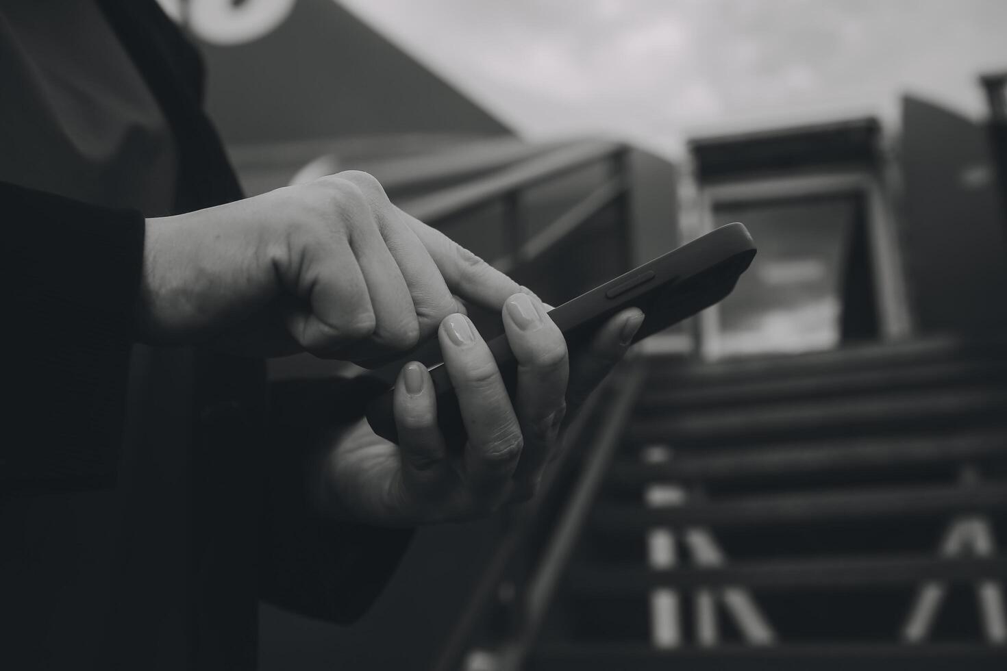 Young asian woman in international airport, using mobile smartphone and checking flight at the flight information board photo