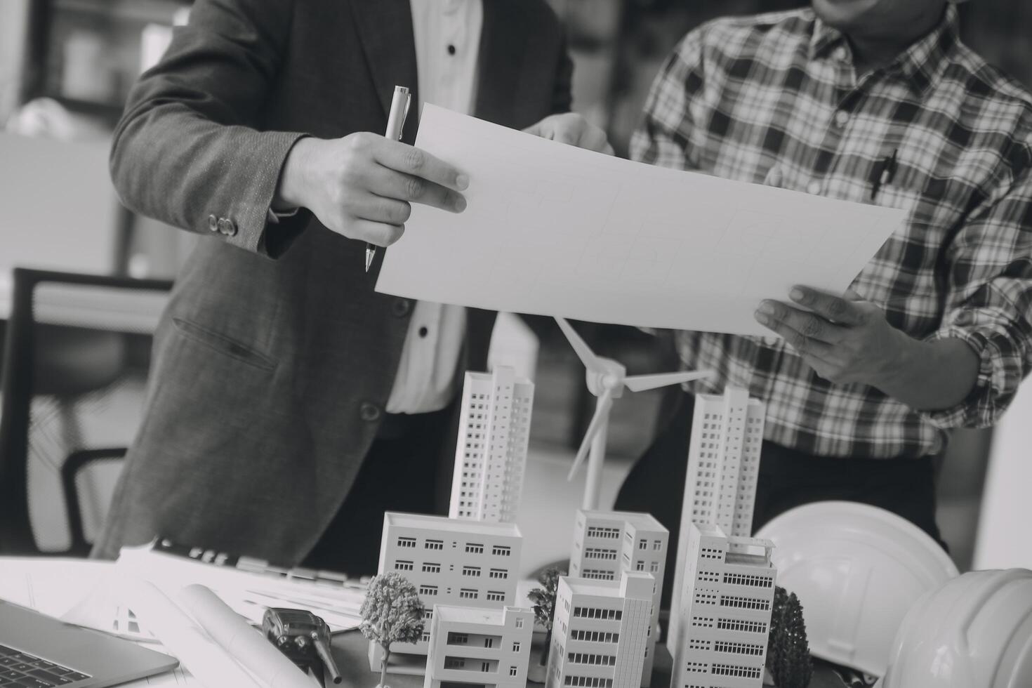 Construction and structure concept of Engineer or architect meeting for project working with partner and engineering tools on model building and blueprint in working site, contract for both companies. photo