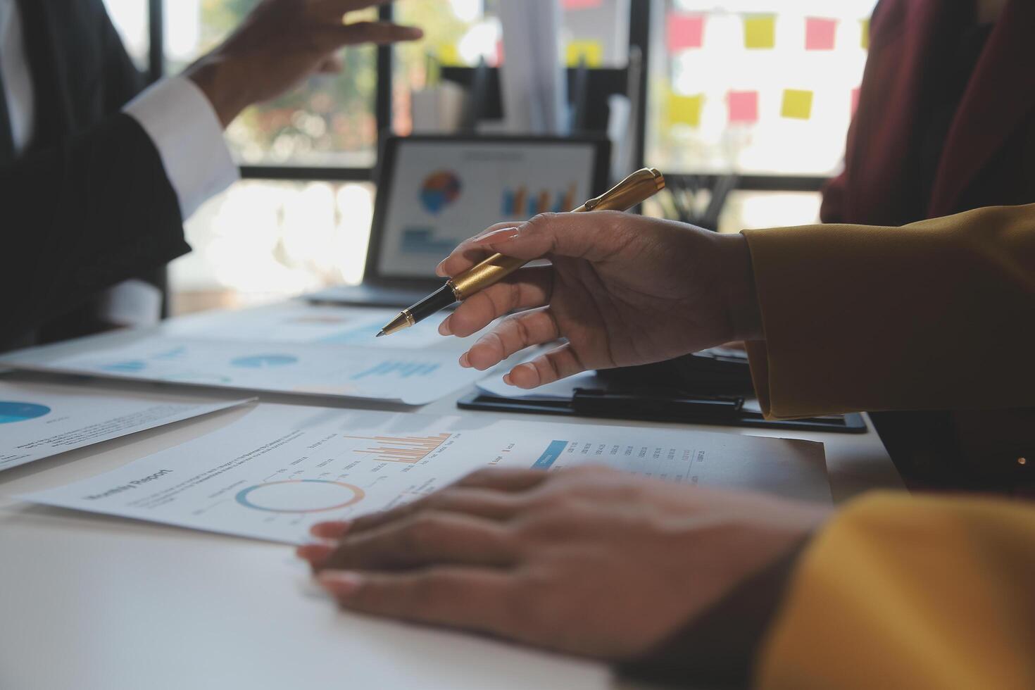 Financial analysts analyze business financial reports on a digital tablet planning investment project during a discussion at a meeting of corporate showing the results of their successful teamwork. photo
