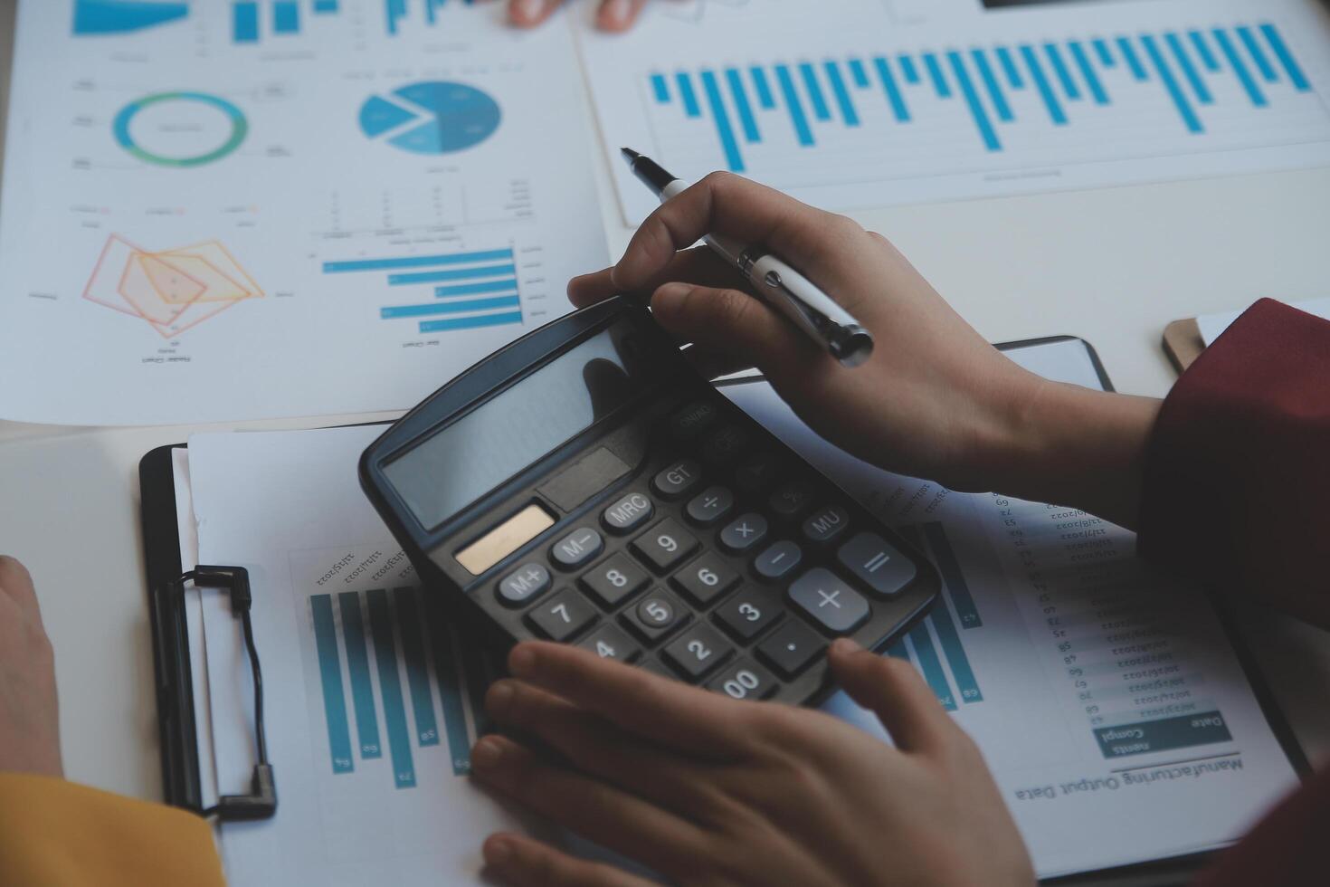 Financial analysts analyze business financial reports on a digital tablet planning investment project during a discussion at a meeting of corporate showing the results of their successful teamwork. photo