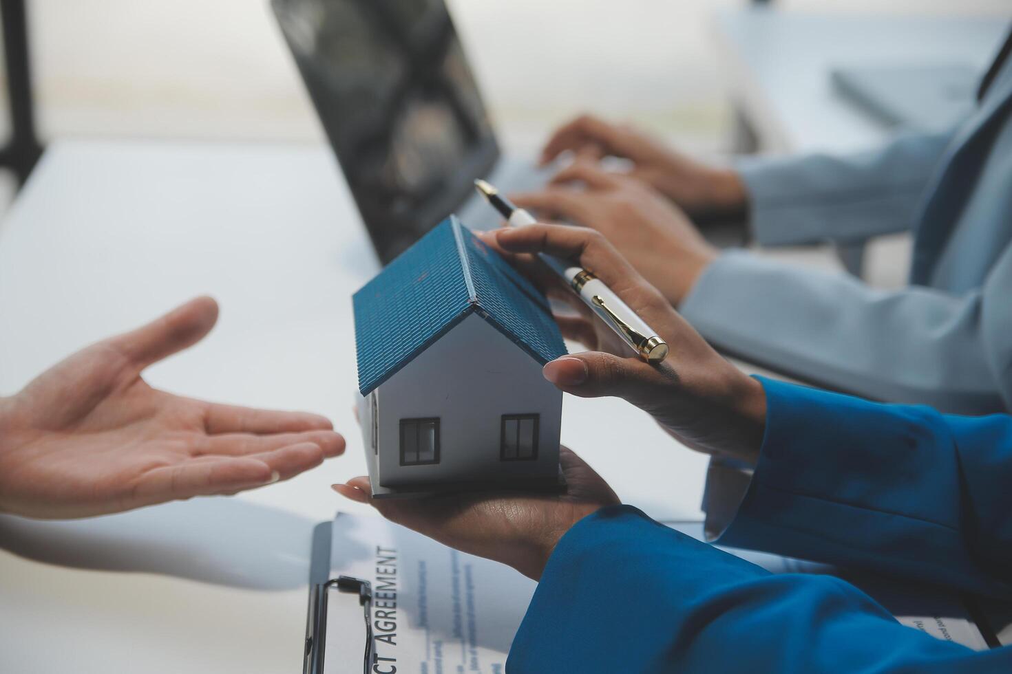 Real estate agent and customer signing contract to buy house, insurance or loan real estate.rent a house,get insurance or loan real estate or property. photo
