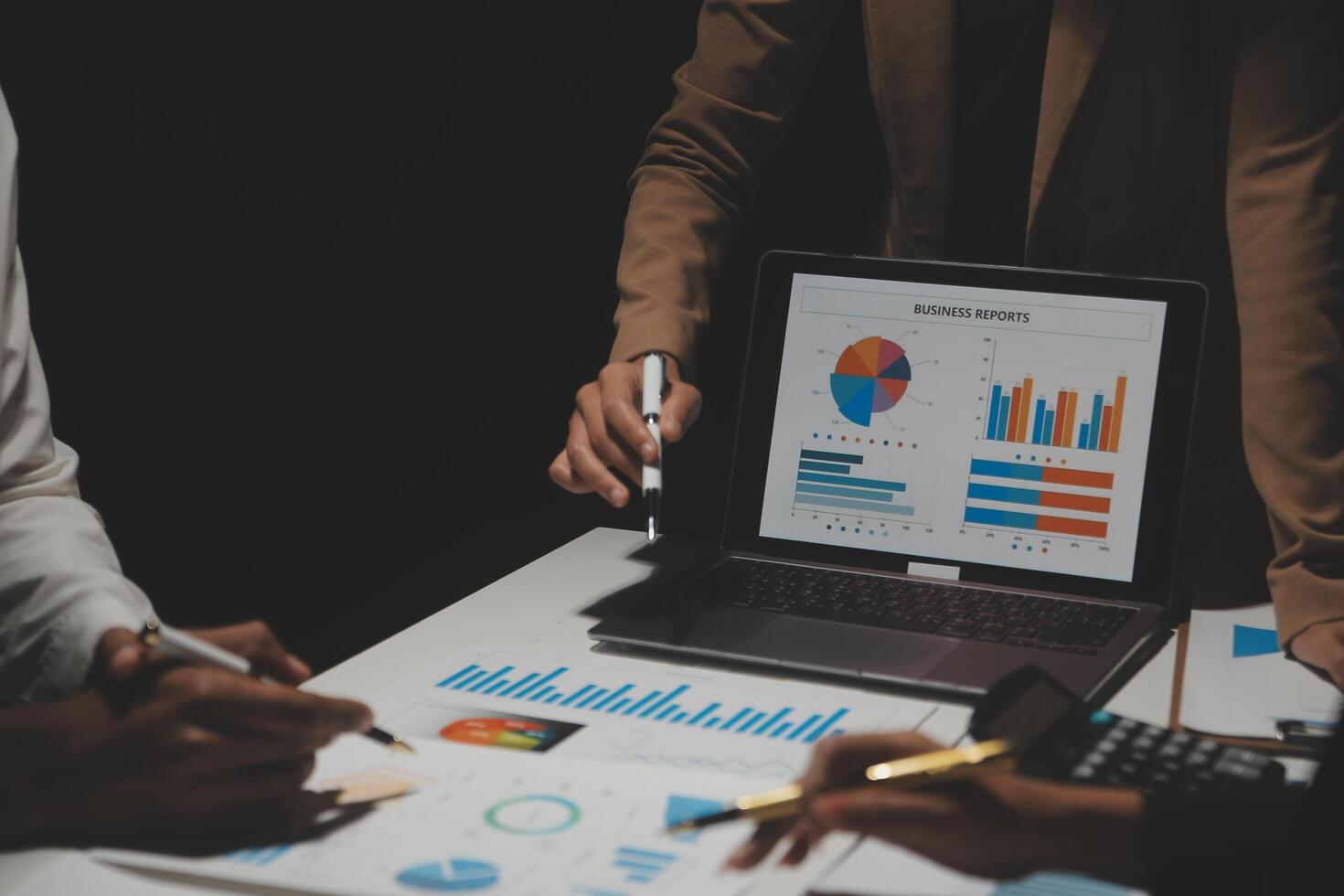 Financial analysts analyze business financial reports on a digital tablet planning investment project during a discussion at a meeting of corporate showing the results of their successful teamwork. photo