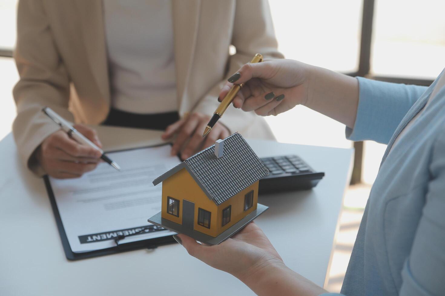 Real estate agent and customer signing contract to buy house, insurance or loan real estate.rent a house,get insurance or loan real estate or property. photo