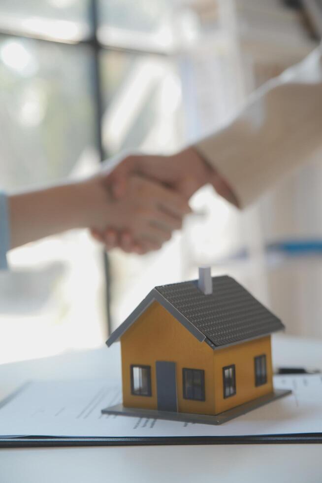 Real estate agent and customer signing contract to buy house, insurance or loan real estate.rent a house,get insurance or loan real estate or property. photo