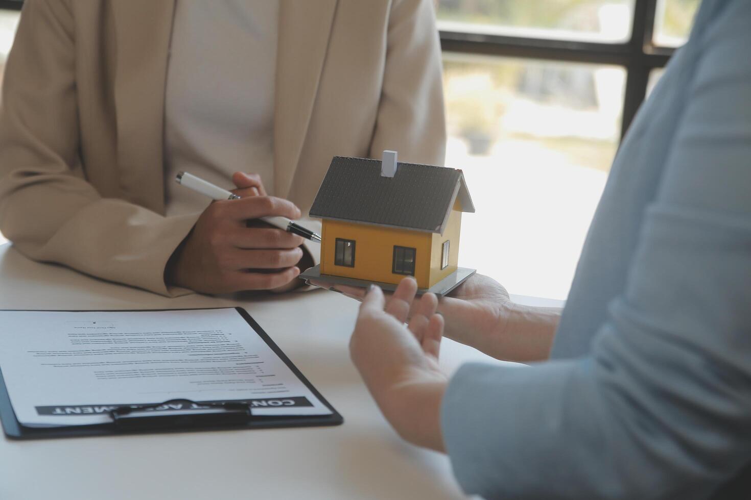 Real estate agent and customer signing contract to buy house, insurance or loan real estate.rent a house,get insurance or loan real estate or property. photo