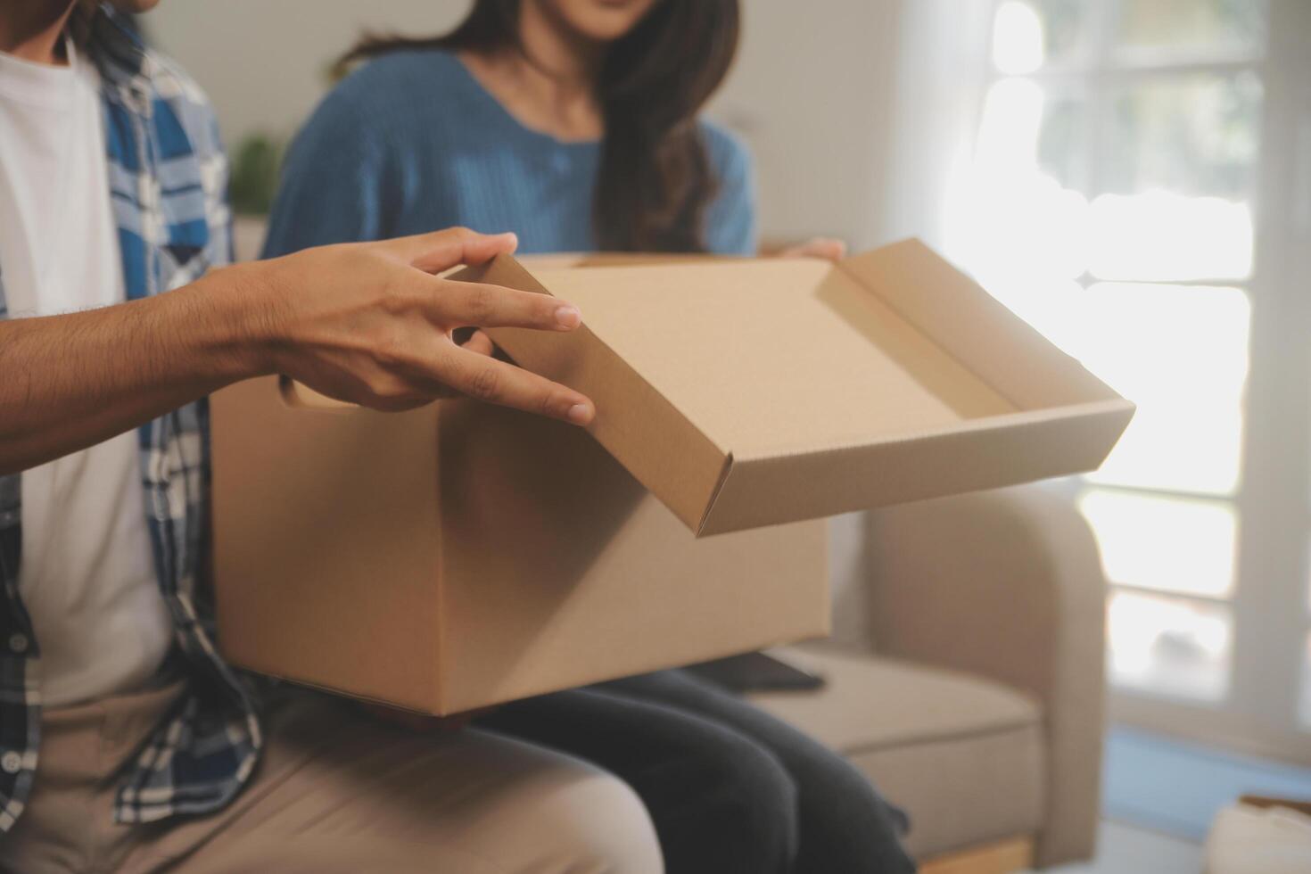 Two Asian blogger showing clothes in front of the camera to recording vlog video live streaming at her shop. Online Shopping Cart notion. on sofa at home photo
