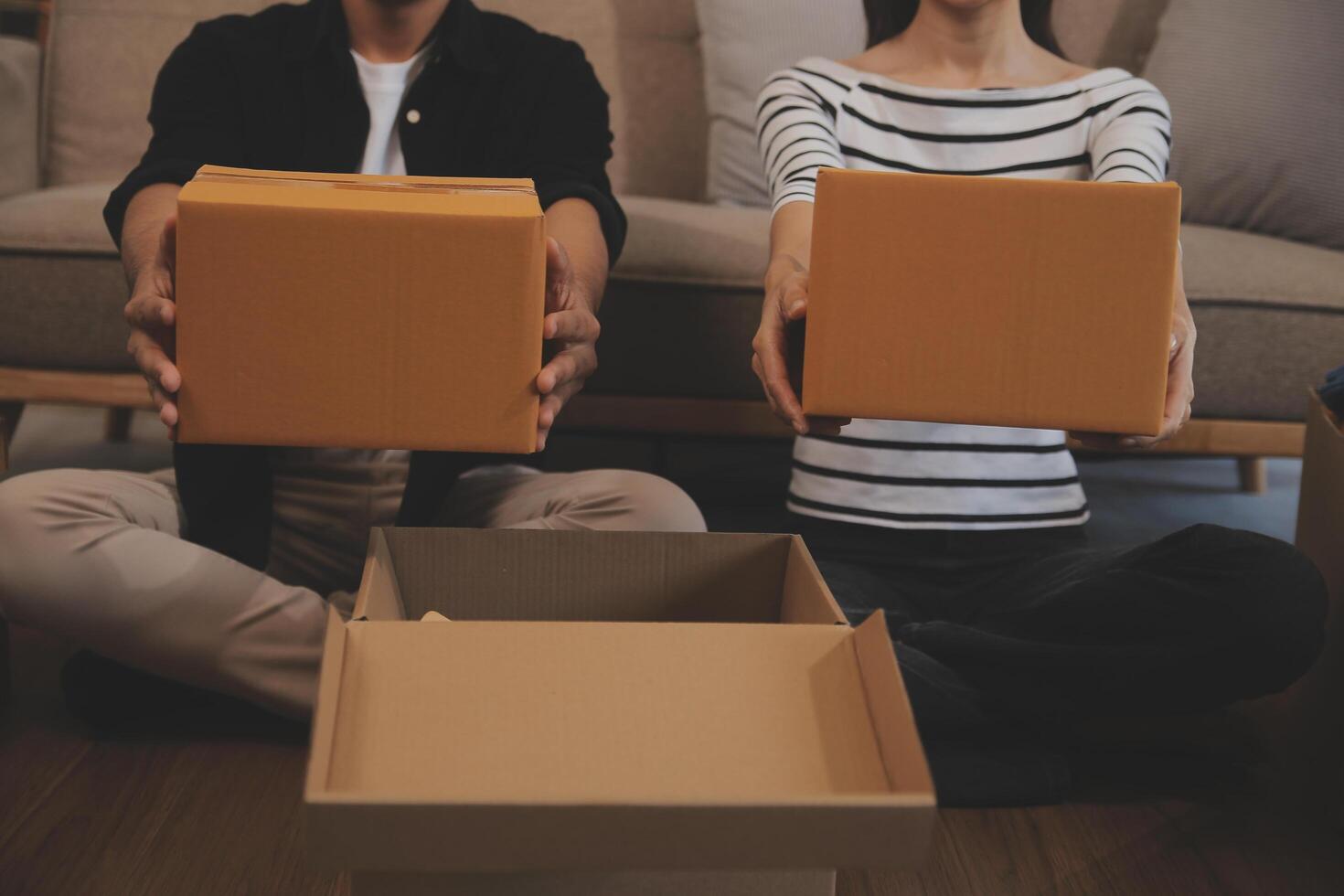 Two Asian blogger showing clothes in front of the camera to recording vlog video live streaming at her shop. Online Shopping Cart notion. on sofa at home photo