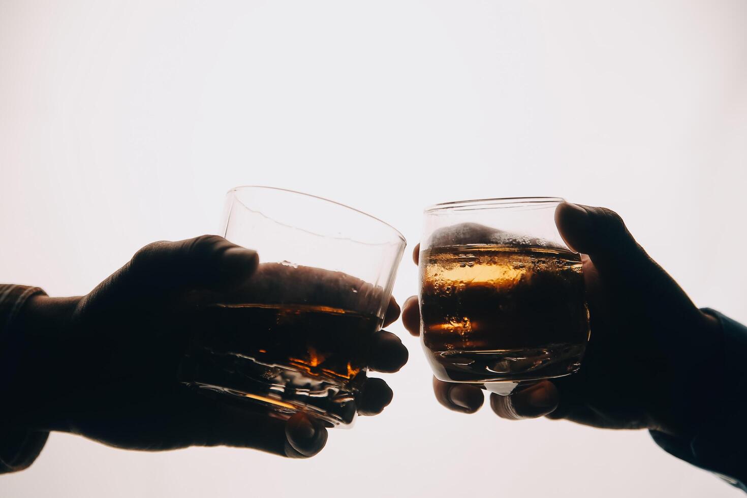 Whiskey splashing out of glass, isolated on white background photo