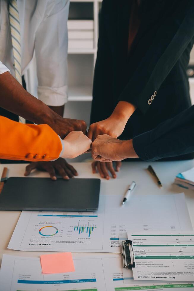 Large business team showing unity with their hands together photo