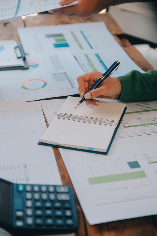 Co working conference, Business team meeting present, investor colleagues discussing new plan financial graph data on office table with laptop and digital tablet, Finance, accounting, investment. photo