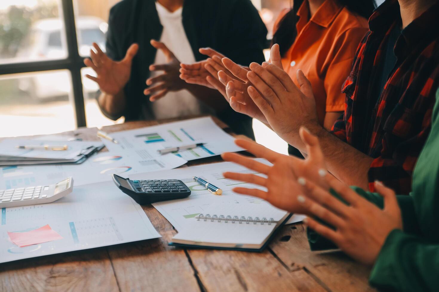 Cheerful business colleagues applauding in meeting at coworking office photo