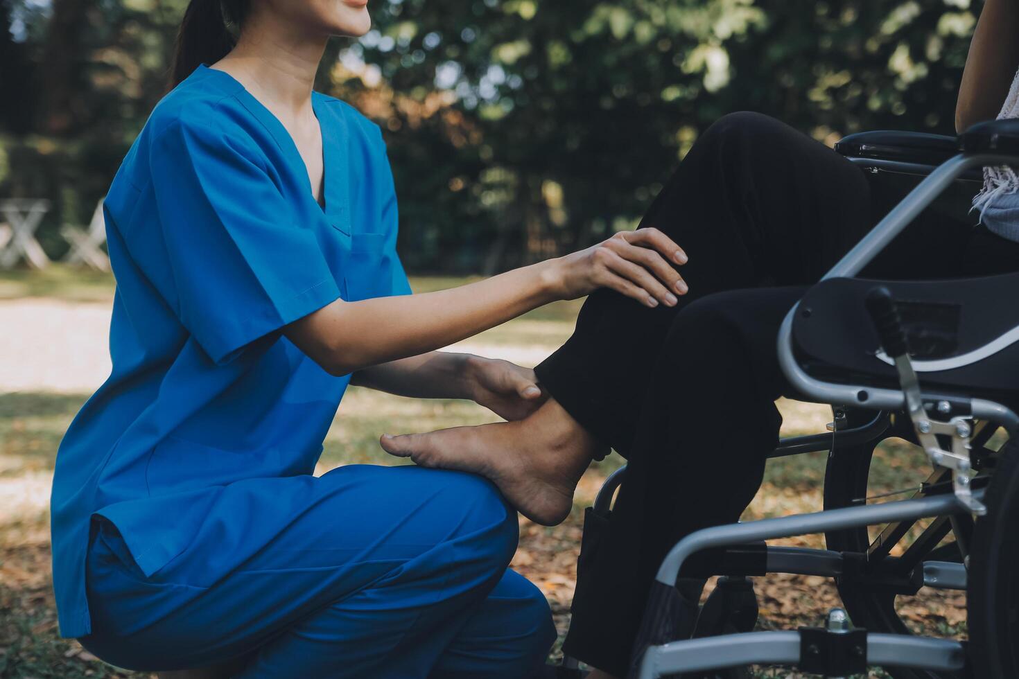 joven fisioterapeuta asiática que trabaja con una anciana caminando con un andador foto