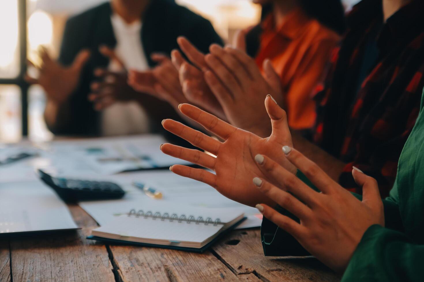 Cheerful business colleagues applauding in meeting at coworking office photo