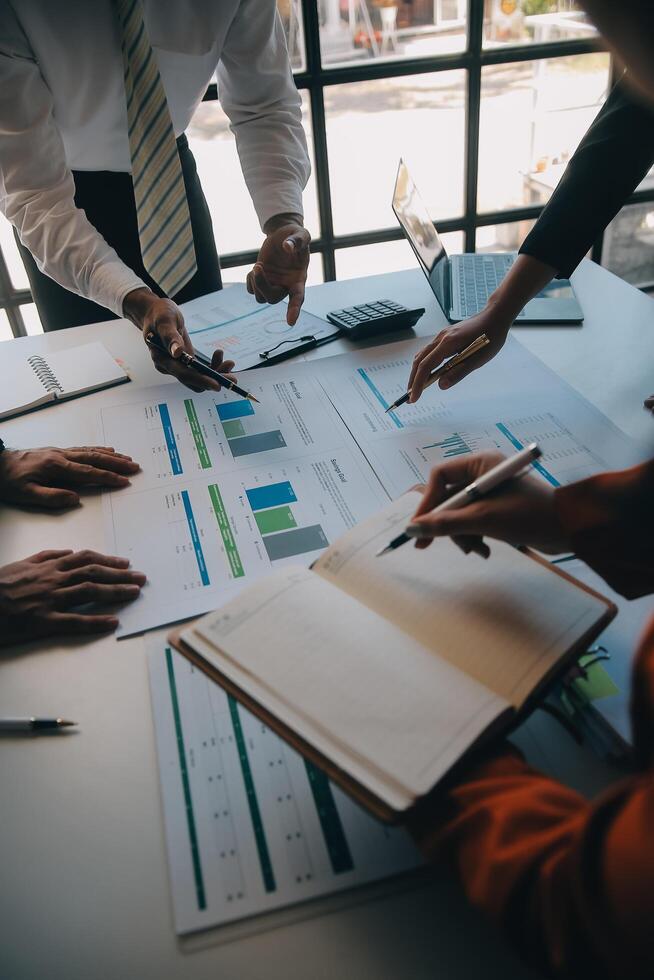 Business team working with new startup project plan and discussion information for financial strategy with laptop and digital tablet in a modern business lounge. photo