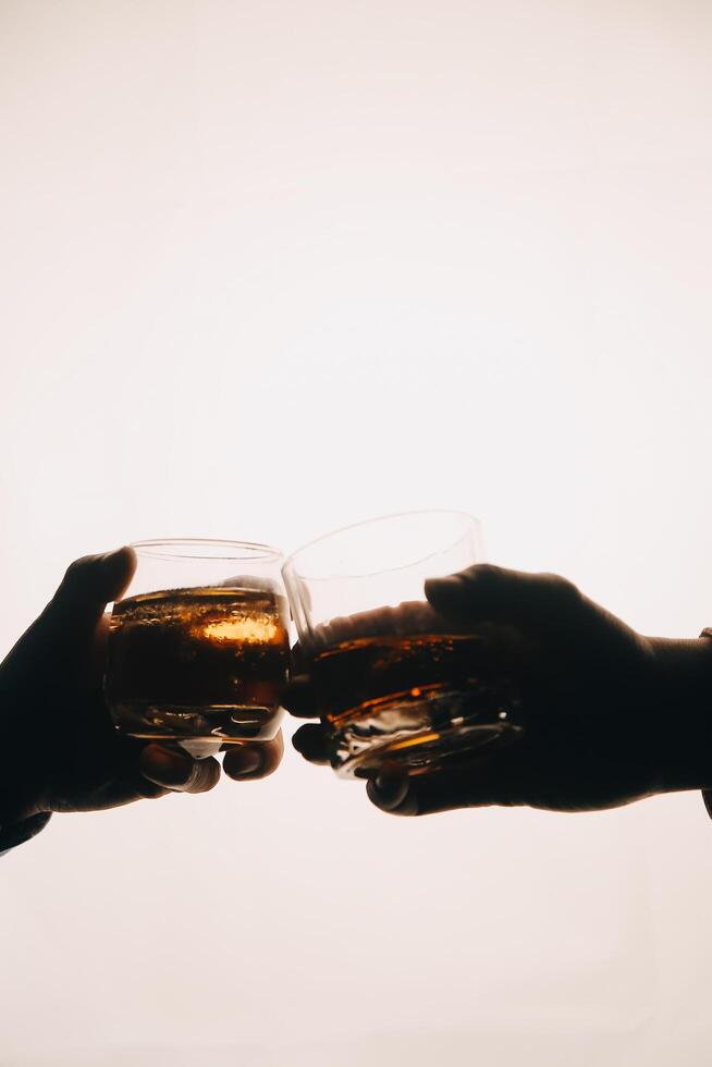 Whiskey splashing out of glass, isolated on white background photo