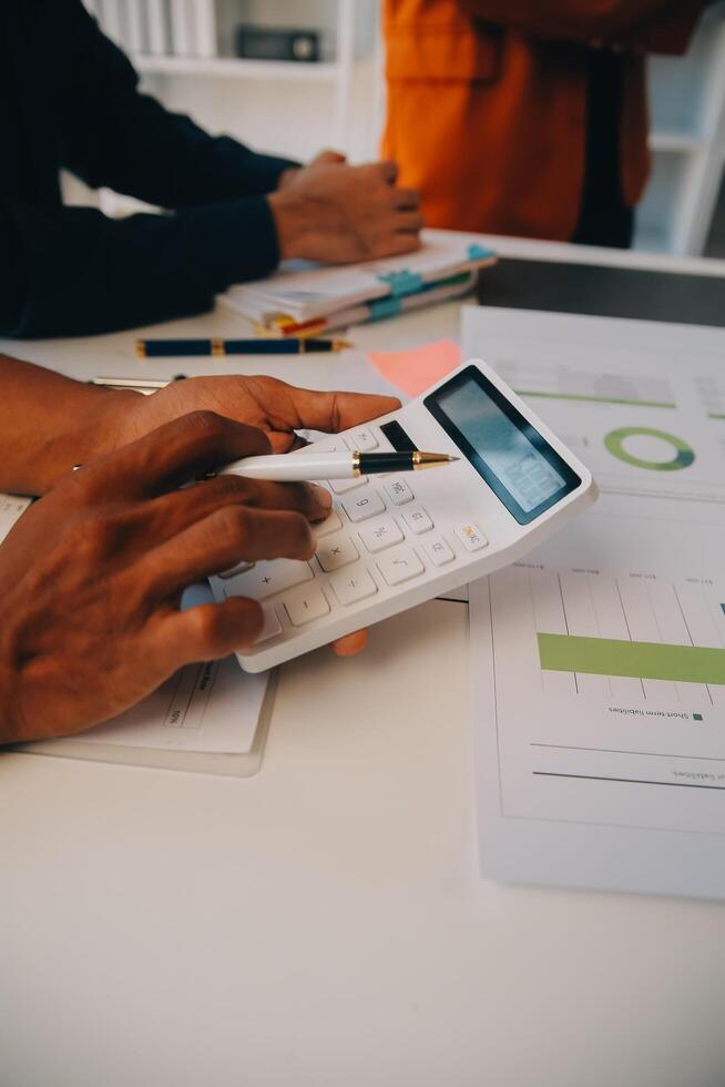 Co working conference, Business team meeting present, investor colleagues discussing new plan financial graph data on office table with laptop and digital tablet, Finance, accounting, investment. photo