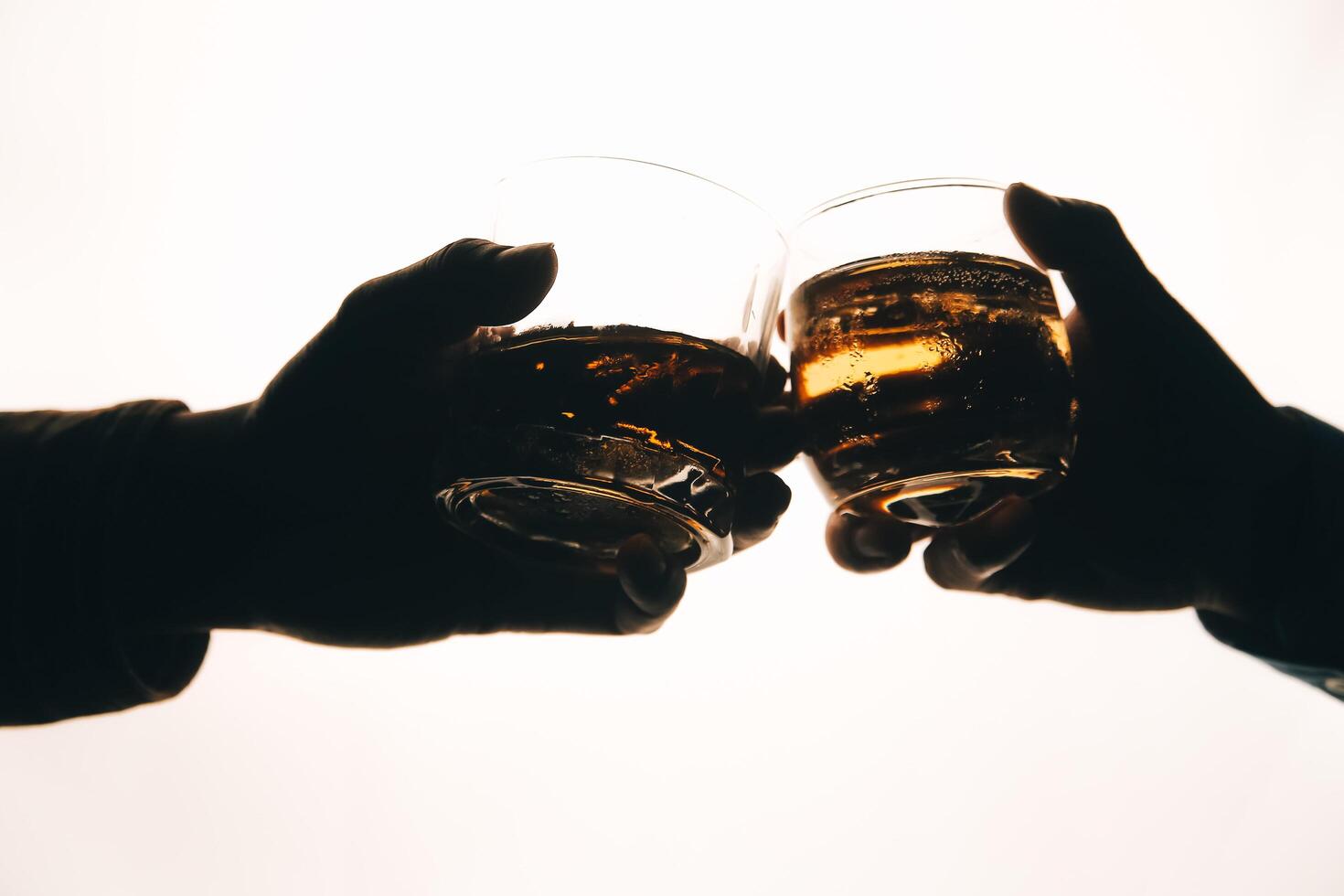 Whiskey splashing out of glass, isolated on white background photo