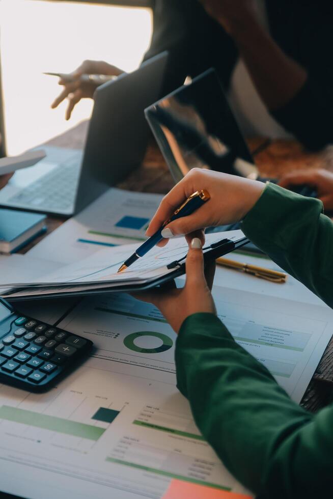 Co working conference, Business team meeting present, investor colleagues discussing new plan financial graph data on office table with laptop and digital tablet, Finance, accounting, investment. photo
