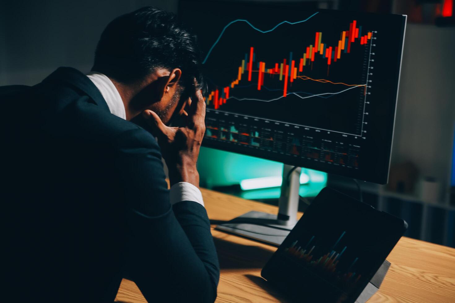 Thoughtful focused successful caucasian male stock investor, broker, financial adviser, sits at work desk, looks at computer, pensively analyze risks and prospects, rise or fall of cryptocurrency coin photo