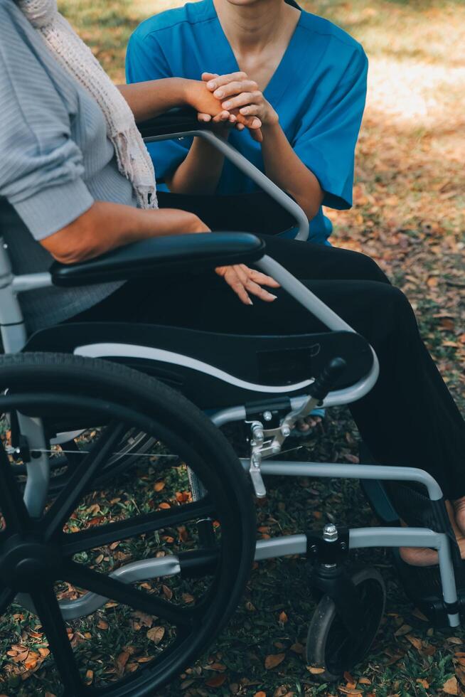 Young asian caretaker with 60s asia elderly woman consulting and encourage, take a history and recommend the right treatment to live happily in retirement, holding hands and encouraging photo