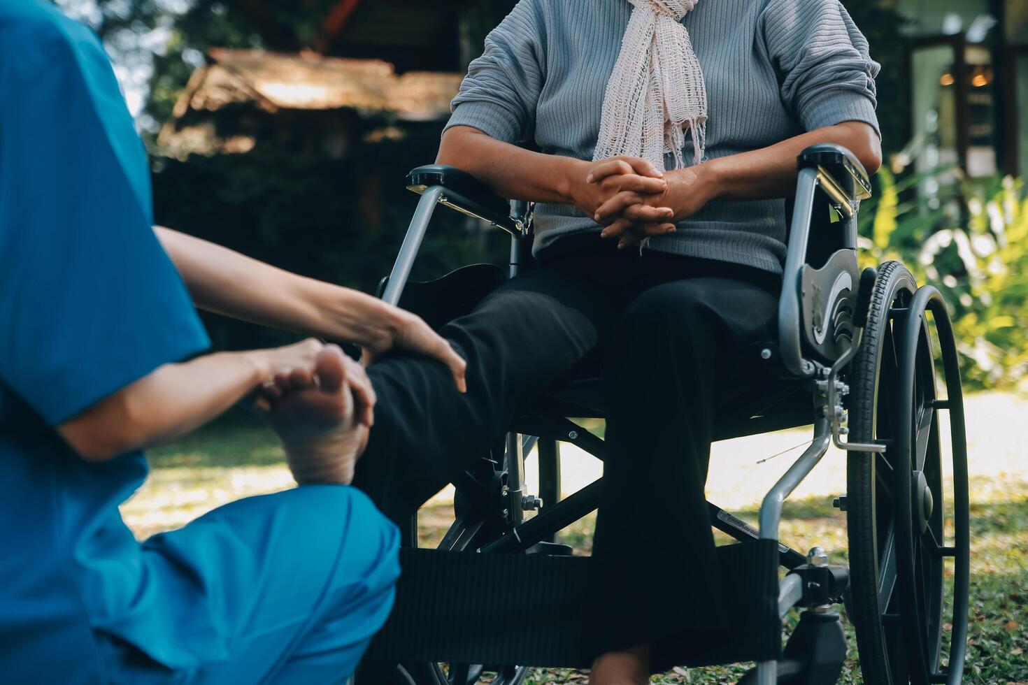 young asian physical therapist working with senior woman on walking with a walker photo