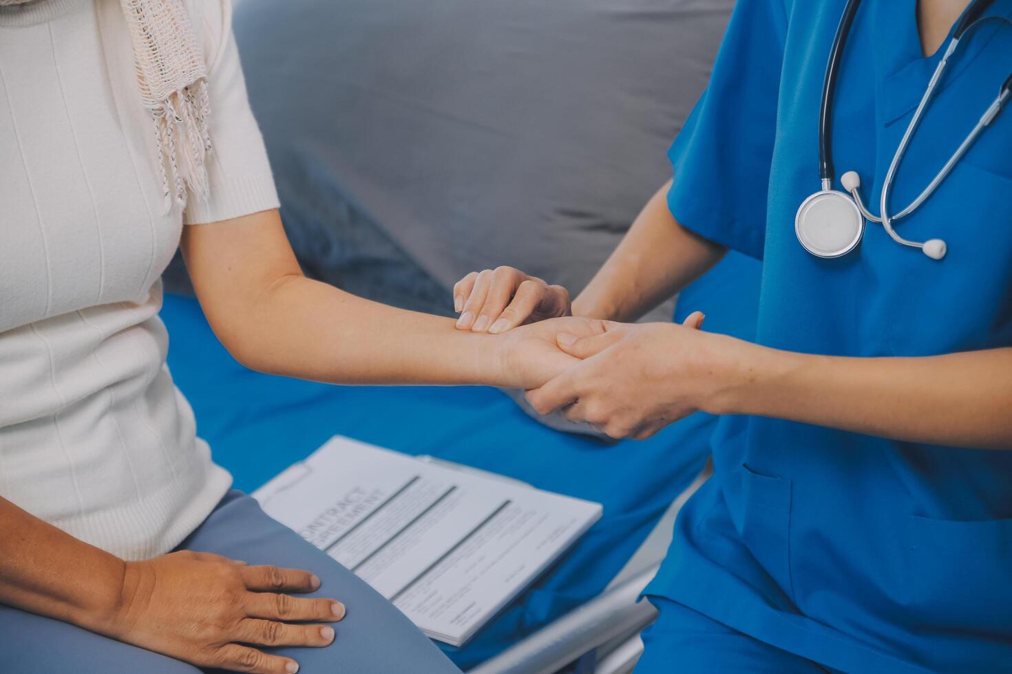 Young asian caretaker with 60s asia elderly woman consulting and encourage, take a history and recommend the right treatment, holding hands and encouraging photo