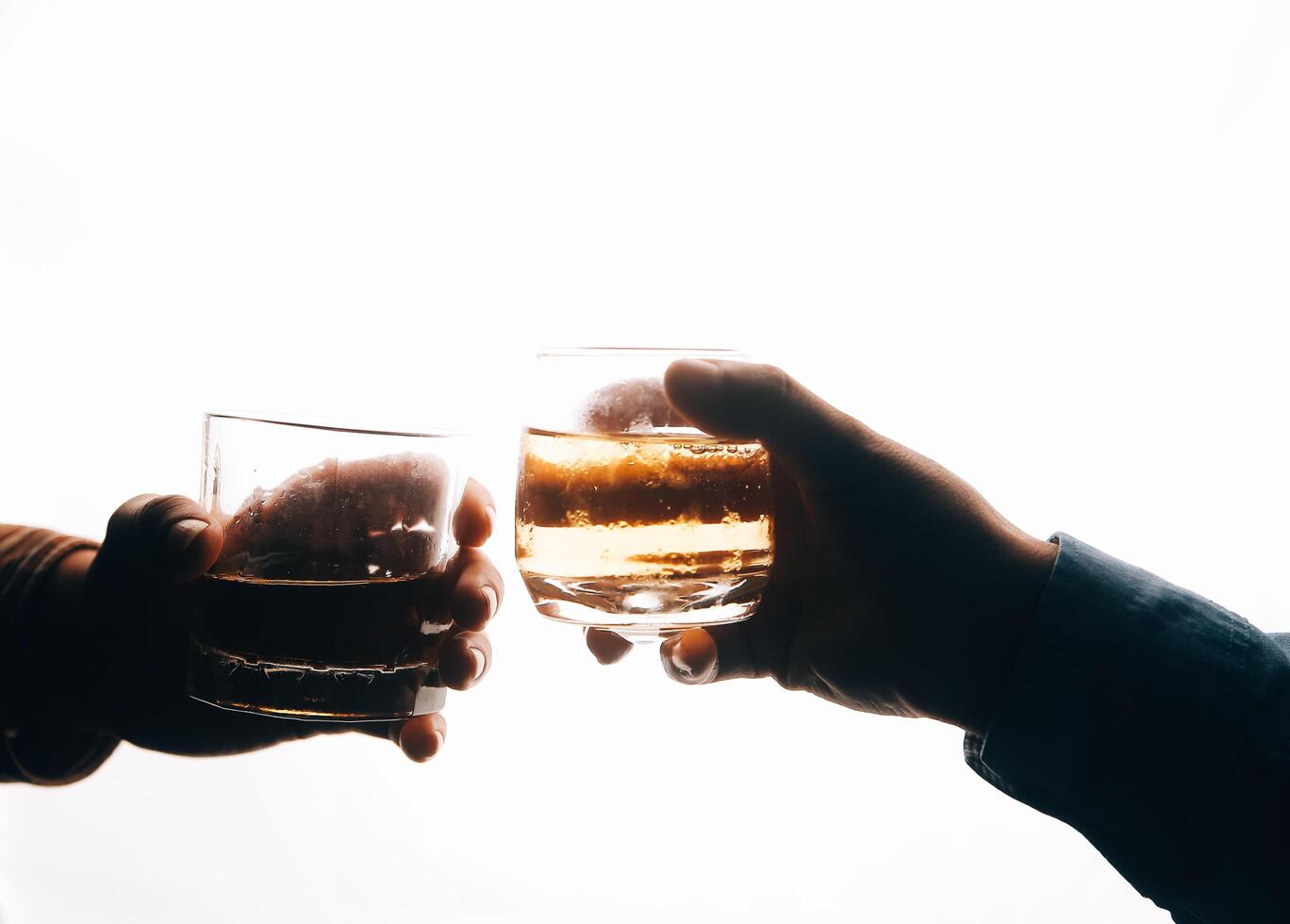 Whiskey splashing out of glass, isolated on white background photo